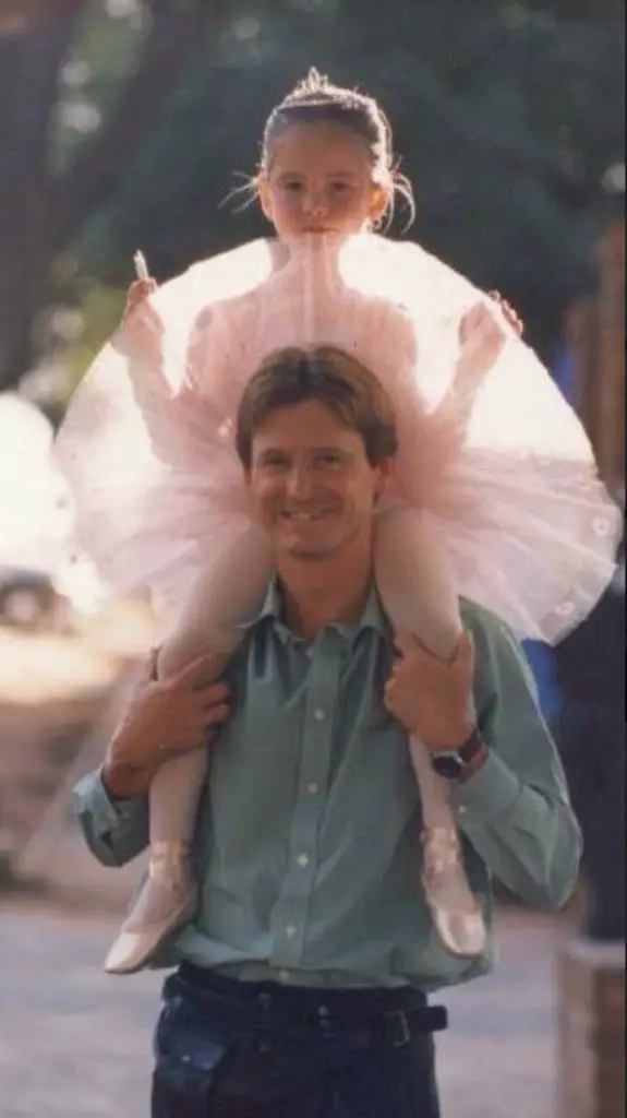 Ashley Dean on dad's shoulders to first performance